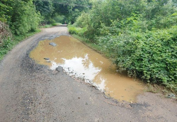 Watch out for: Rainwater pooling in village road ditches   கவனம் செலுத்துங்க: கிராம ரோடு பள்ளங்களில் தேங்கும் மழைநீர்